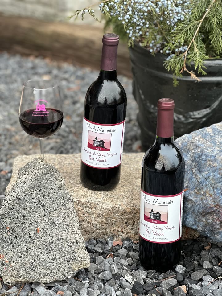Happy New Year! Our wine of the month for January is Petit Verdot. The words Petit Verdot roughly translate to "little green one" in French. Petit Verdot is a red grape native to the Bordeaux region of France and is most famous for being one of the accepted grapes allowed in Bordeaux red wine. At North Mountain, we are serving 2 vintages of our Petit Verdot. Both are 100% Petit Verdot. The 2019 has smooth tannins, and vanilla undertones with a zestier finish. This is one that can lay down for several more years. The 2017 is a much softer version with lower tannins. Both were aged 10 months in French Oak. Come on over, try both of our Petit Verdots and receive $10 off the purchase of 2 bottles.